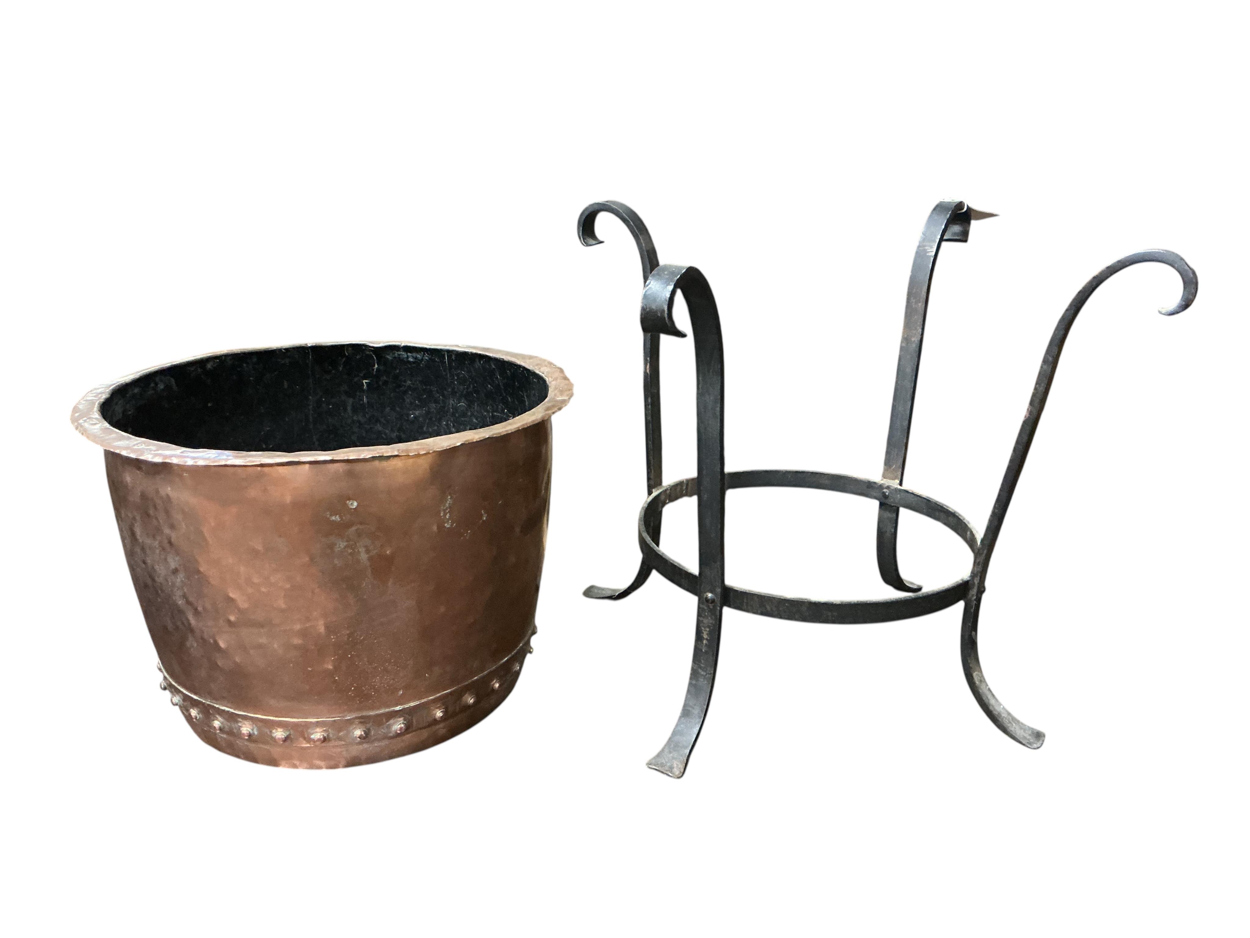 A small Victorian circular copper copper, raised in a wrought iron frame, width 64cm, height 50cm